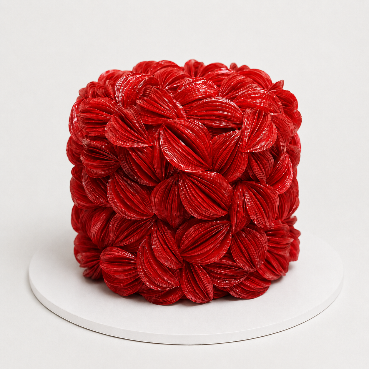 Luxury Red wafer paper petal statement cake with textured floral wafer paper design on a white cake board
