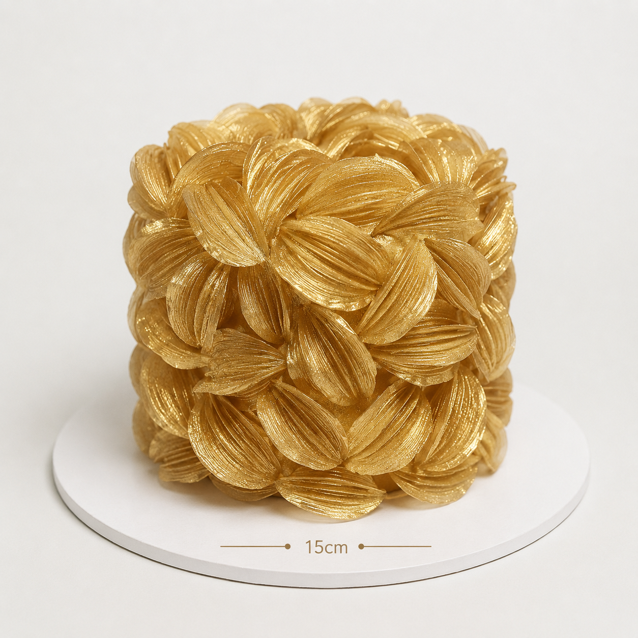 Luxury Gold wafer paper petal statement cake with textured floral wafer paper design on a white cake board