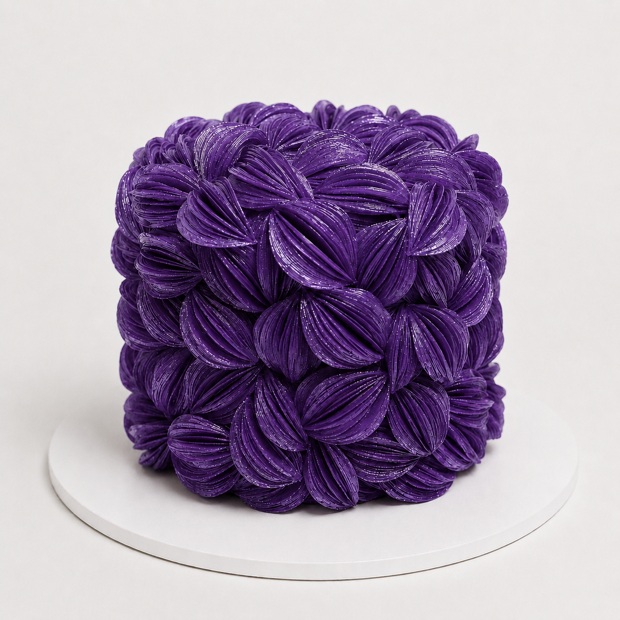 Luxury purple wafer paper petal statement cake with textured floral wafer paper design on a white cake board
